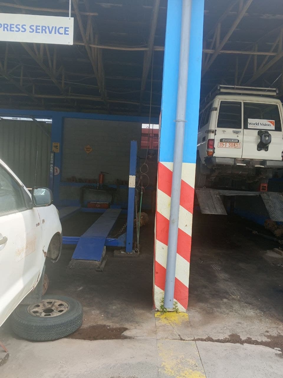 Vehicle lifted on hydraulic equipment in the repair bay