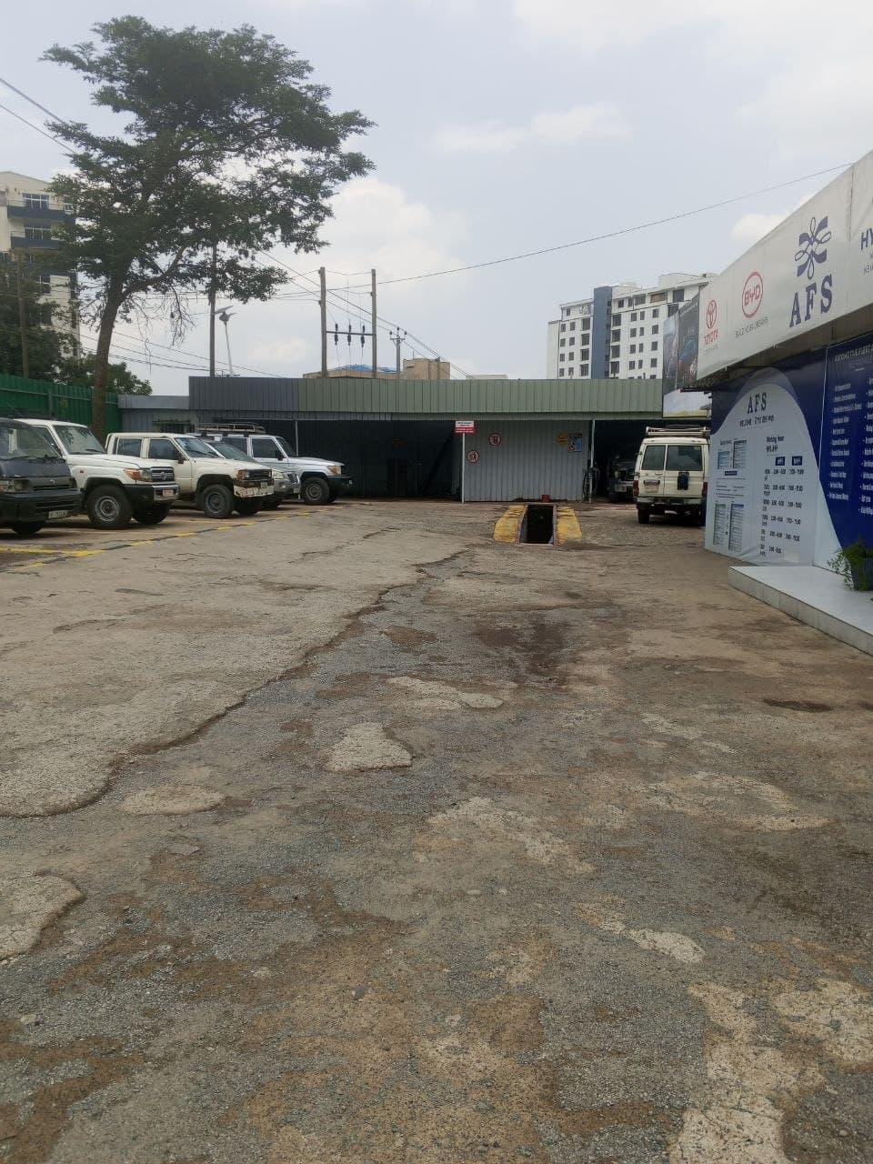 AFS service center with office building, fleet parking, and inspection pit