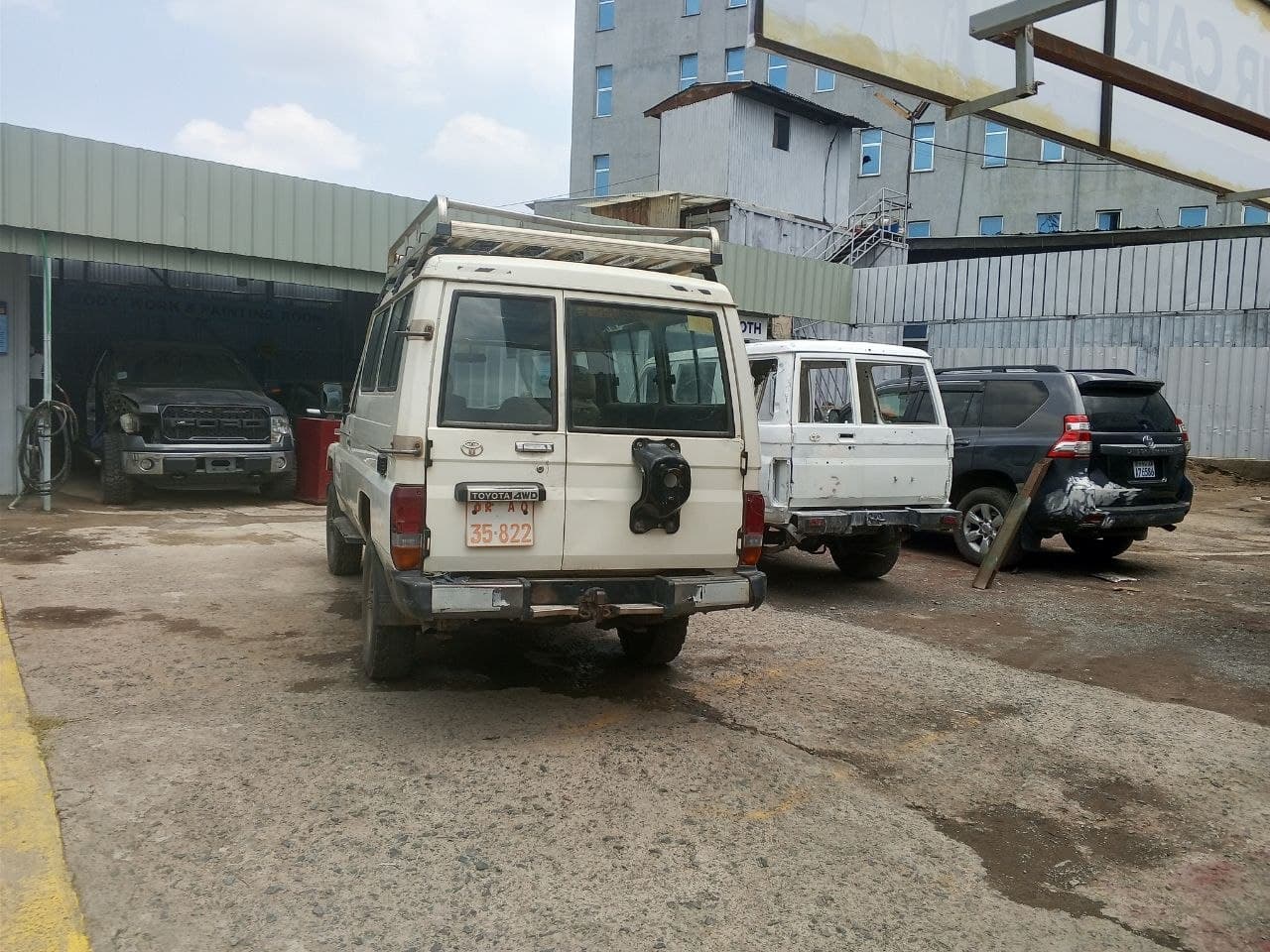 Body work and painting service area with fleet vehicles