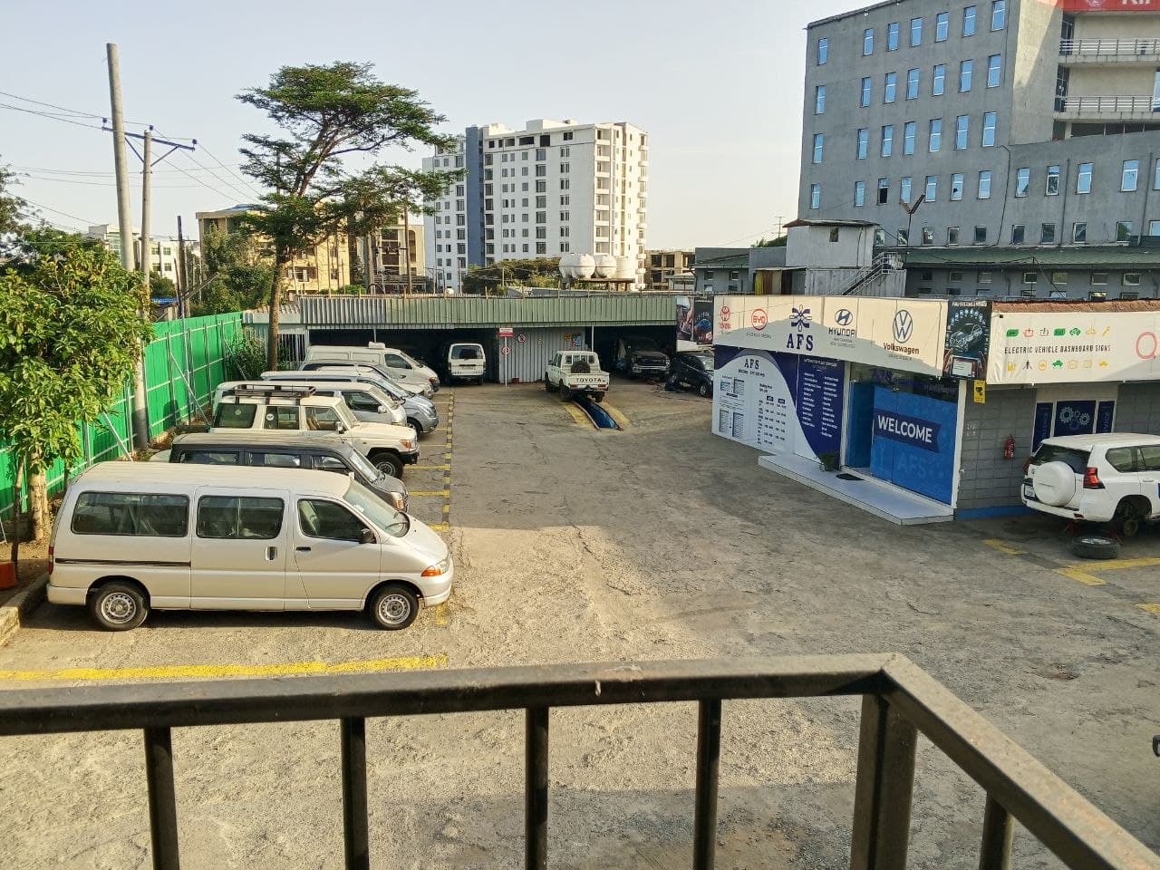 AFS campus overview with office, service bays, and vehicle fleet